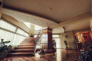 a staircase in a building with wooden floors and windows at Denisa Boutique in Poiana Brasov