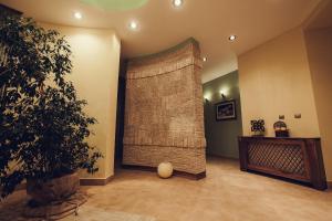 a room with a large bamboo curtain in a room with a plant at Denisa Boutique in Poiana Brasov