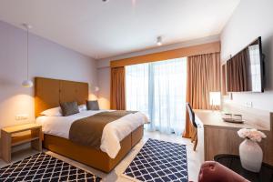 Postel nebo postele na pokoji v ubytování Hotel Seventh