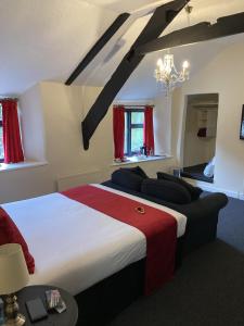 a bedroom with a large bed and a chandelier at The Cridford Inn in Trusham