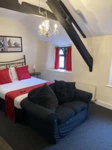 a bedroom with a bed and a couch at The Cridford Inn in Trusham