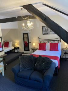 a bedroom with a bed and a couch in a room at The Cridford Inn in Trusham