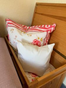 two pillows are sitting in a wooden drawer at Haus Boy Jensen Wohnung Sonnenplatz in Wenningstedt