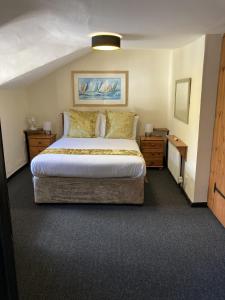 a bedroom with a large bed and two night stands at The Cridford Inn in Trusham