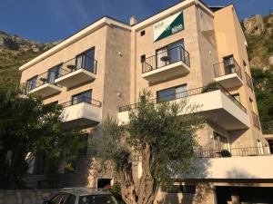 a building with a car parked in front of it at REZEVICI BOUTIQUE VILLA in Petrovac na Moru