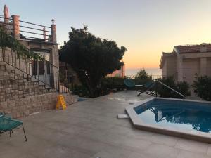 a backyard with a swimming pool and a house at REZEVICI BOUTIQUE VILLA in Petrovac na Moru