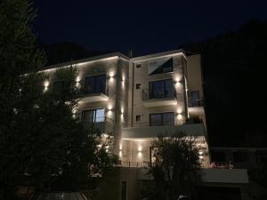 a building with lights on it at night at REZEVICI BOUTIQUE VILLA in Petrovac na Moru
