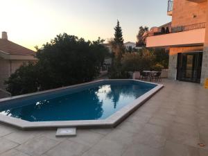 a swimming pool in the backyard of a house at REZEVICI BOUTIQUE VILLA in Petrovac na Moru