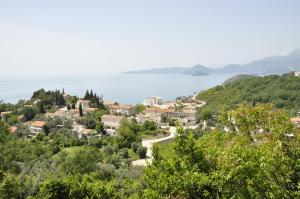 a small town on a hill overlooking the water at REZEVICI BOUTIQUE VILLA in Petrovac na Moru