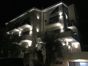 a night view of a building with lights on at REZEVICI BOUTIQUE VILLA in Petrovac na Moru