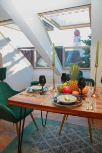 a dining room table with fruit and wine glasses at 1001 Nacht Bodensee in Kressbronn am Bodensee