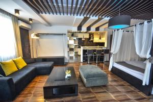 a living room filled with furniture and a couch at Boutique Hotel Medusa in Batumi