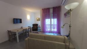 a living room with a couch and a table at oleandra in Nesso