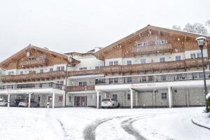 a large building with snow in front of it at AlpinResort Kaprun 2 in Kaprun