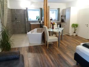 a bathroom with a tub and a table and a shower at Apartment Riedhof in Fahrenbach +20 photos