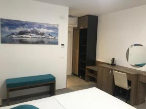 a room with a bed and a desk and a mirror at REZEVICI BOUTIQUE VILLA in Petrovac na Moru