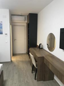 a room with a wooden desk and a mirror at REZEVICI BOUTIQUE VILLA in Petrovac na Moru