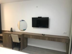 a desk with a television and a mirror on a wall at REZEVICI BOUTIQUE VILLA in Petrovac na Moru