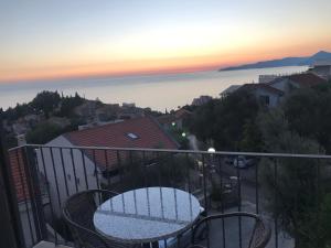 a balcony with a table and a view of the ocean at REZEVICI BOUTIQUE VILLA in Petrovac na Moru