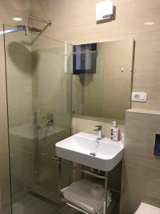 a bathroom with a sink and a glass shower at REZEVICI BOUTIQUE VILLA in Petrovac na Moru
