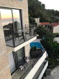 a view from the balcony of a house with a pool at REZEVICI BOUTIQUE VILLA in Petrovac na Moru
