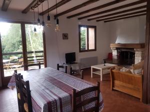 a living room with a table and a fireplace at Orée du Bois in Abreschviller