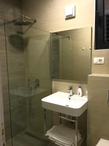 a bathroom with a sink and a glass shower at REZEVICI BOUTIQUE VILLA in Petrovac na Moru