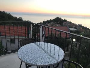 a table and chairs on a balcony with a view at REZEVICI BOUTIQUE VILLA in Petrovac na Moru