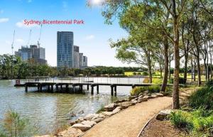 a pier in a park next to a body of water at Greenview in Sydney Olympic Park in Sydney