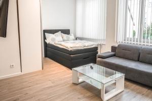 a living room with a couch and a coffee table at Central Apartments Aalen in Aalen