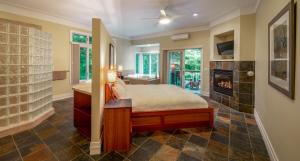 a bedroom with a bed and a fireplace at Pigeon Creek Inn - Adults Only in Holland