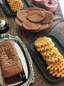 a table with waffles and a mirror and waffles and bread at Le Jardin Des Secrets in Namur