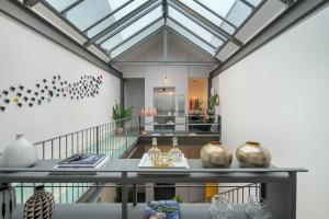 a room with a glass ceiling with vases on a table at Canto De Luz - Luxury Maison in Porto