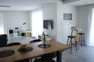 a living room with a wooden table and chairs at Fewo Haus Edith in Lug