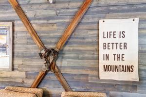 a sign hanging on a wall with two chairs at Fireside Inn & Hostel in Breckenridge