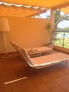 a room with a couch and a table and a table and a window at Apartamento Casas del Mar in Oliva