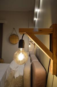 a light bulb hanging over a bed in a room at Langi Apartments in Mesolongion