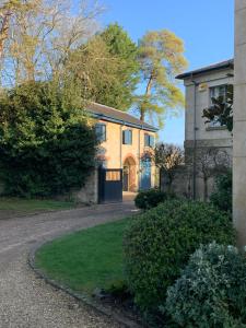 a house with a driveway in front of it at The Old Vicarage, Evenley. Brackley. in Brackley