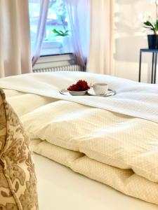 RS Apartment Baden-Baden في بادن بادن: طاولة مع طبق من الطعام على سرير