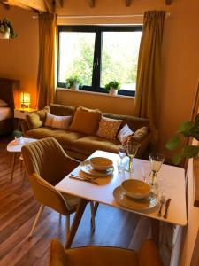 a living room with a table and a couch at Ferienwohnungen Park Café am Kurpark in Bernkastel-Kues