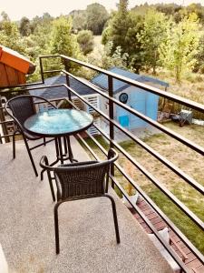 a table and chairs on the balcony of a house at Apartament z balkonem blisko plaży in Niechorze