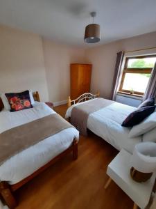 1 Schlafzimmer mit 2 Betten und einem Fenster in der Unterkunft Lovely ballina townhouse in Ballina