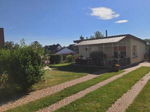 a house with a greenhouse in a yard at Ferienhaus Cziuppa in Bad Salzungen