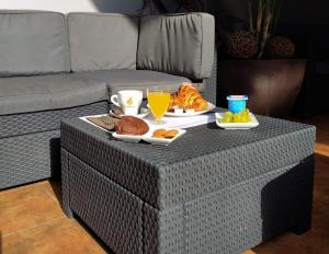 a table with a tray of breakfast food on it at HOTEL DEL NORA in Noreña