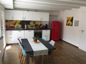 a kitchen with a table and a red refrigerator at Auszeit in Ettenheim