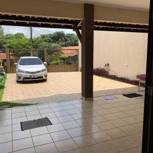 a white car parked in a driveway in a yard at Ótima Casa em Guaramiranga in Guaramiranga +3 photos