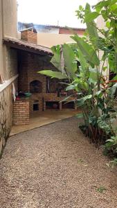 a brick patio with a fireplace in a house at Ótima Casa em Guaramiranga in Guaramiranga