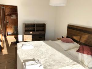 Schlafzimmer mit einem großen Bett mit einem Kopfteil aus Holz in der Unterkunft Zu Hause am See - Pool, Sauna, Fitnessraum in Schluchsee