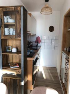 a kitchen with wooden cabinets and a counter top at Zu Hause am See - Pool, Sauna, Fitnessraum in Schluchsee +20 photos