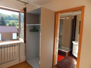 a bathroom with a walk in shower next to a window at Вілла ЕДЕЛЬВЕЙС in Morshin